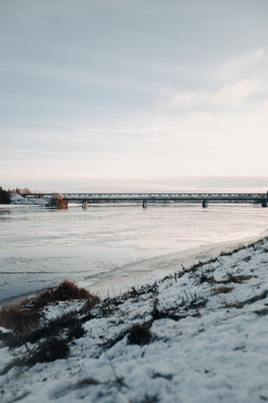 Railway bridge over river in autumn in Rovaniemi, Laplandの写真素材