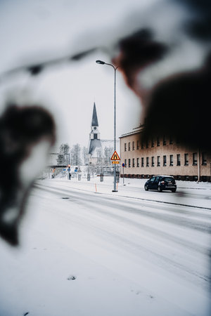 Shot of Rovaniemi church between snowy leaves in Rovaniemi, Laplandの写真素材
