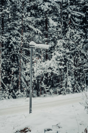 Luolakuja snowy street sign in Rovaniemi, Lapland in winterの写真素材