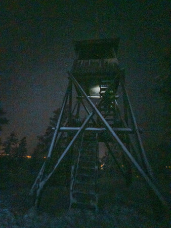 Snowy lookout tower on hill at night in Rovaniemi, Laplandの写真素材