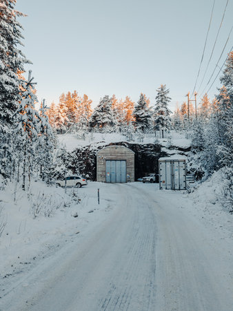 Nuclear bunker under snowy hill with forest in Rovaniemi, Laplandの写真素材
