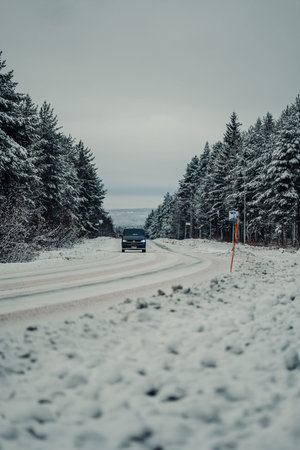 Black van on snowy street in Rovaniemi, Lapland in winter