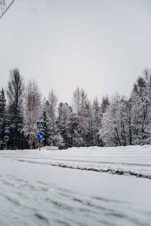 Snowy pedestrian crossing on street in Rovaniemi, Lapland in winterの写真素材