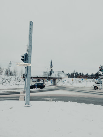 Ounasvaarantie sign on pole next to snowy street in Rovaniemi, Laplandの写真素材