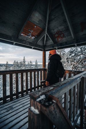 Woman inside Ounasvaara lookout tower in snowy winter in Rovaniemi, Laplandの写真素材