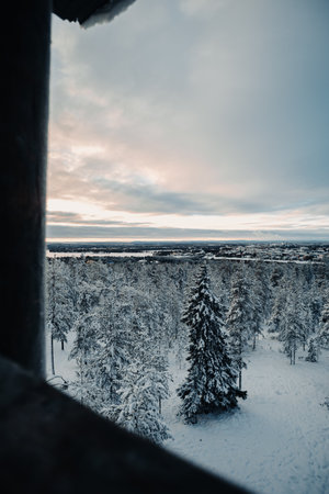 View of Rovaniemi from Ounasvaara lookout tower in winter, snowy trees in Laplandの写真素材