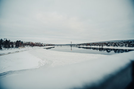 Half frozen Ounasjoki river in Rovaniemi, Lapland shot from railway bridgeの写真素材