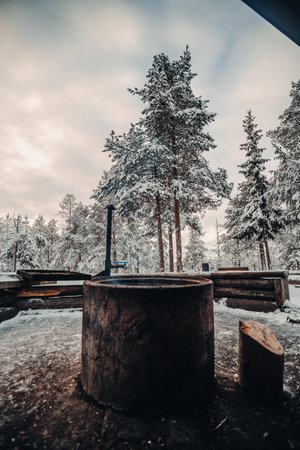 Fireplace outside Ounasvaara laavu in snowy forest in Rovaniemi, Laplandの写真素材