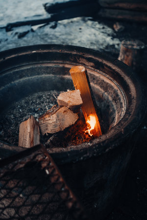 Fire starting in fireplace at Ounasvaara laavu in winter in Rovaniemi, Laplandの写真素材