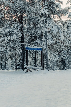 Winter walking trail sign in Ounasvaara snowy forest in Rovaniemi, Laplandの写真素材
