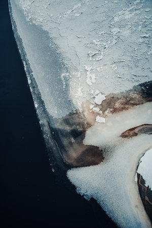 Ice freezing over the Ounasjoki river in Rovaniemi, Lapland in winterの写真素材