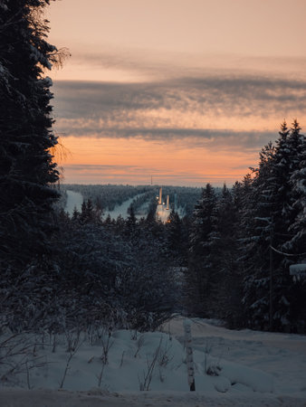 Sunset over snowy Ounasvaara skii jumps in Rovaniemi, Lapland in winterの写真素材