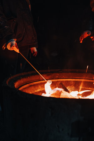 Cooking marshmallow next to fire in Rovaniemi, Laplandの写真素材