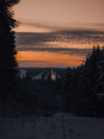 Sunset over ski jumps in snowy Ounasvaara ski resort in Rovaniemi, Lapland