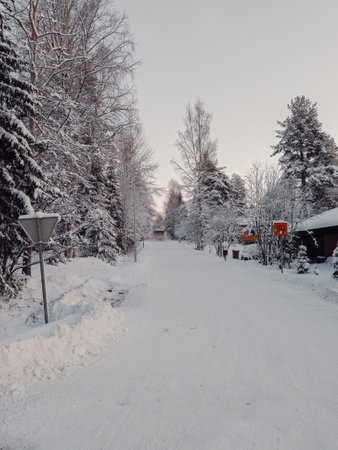 Snowy road in winter in Syvasenvaara neighbourhood in Rovaniemi, Laplandの写真素材