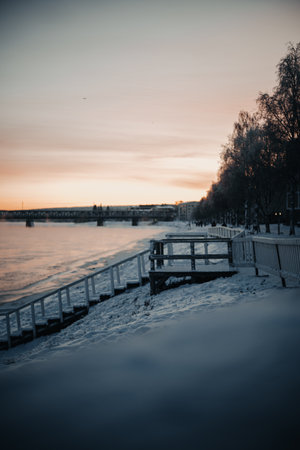 Frozen Ounasjoki river at sunset in Rovaniemi, Lapland in winterの写真素材