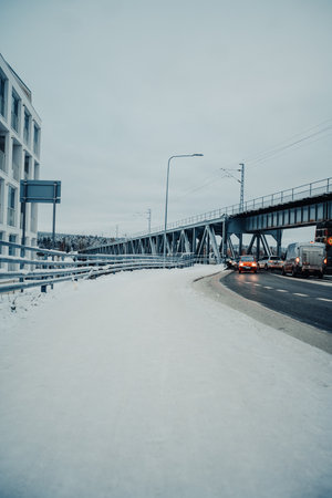 Snowy road onto railway bridge in Rovaniemi, Lapland in winterの写真素材