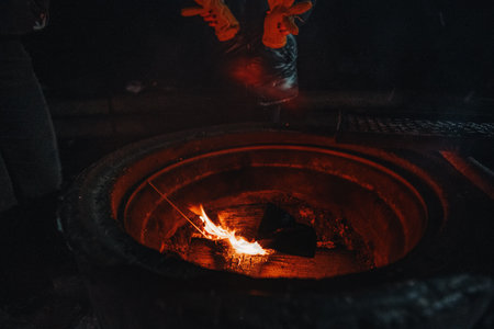 Warming hands over fire at laavu in Rovaniemi, Lapland in winterの写真素材