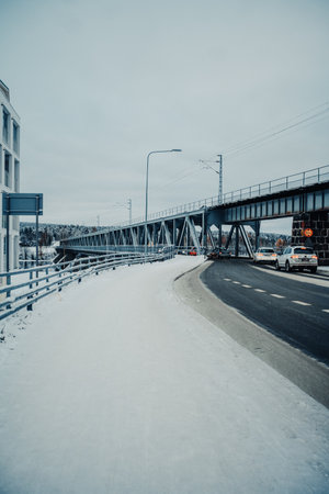 Road onto railway bridge in Rovaniemi, Lapland in winterの写真素材