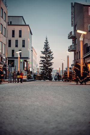 Christmas trees in the center of snowy Rovaniemi at sunset in winter in Laplandの写真素材
