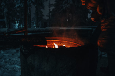 Fireplace at Ounasvaara laavu at night in Rovaniemi, Lapland in winterの写真素材