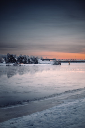 Railway bridge to Ounasvaara at sunset in winter in Rovaniemi, Laplandの写真素材