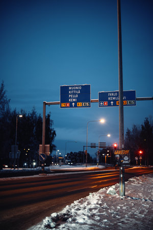 Road signs in the snow at twilight in Rovaniemi, Lapland in winterの写真素材