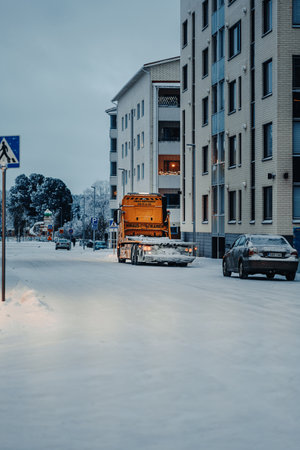 Truck on snowy road at twilight in winter in Rovaniemi, Laplandの写真素材