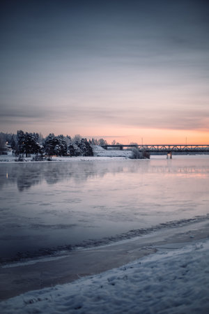 Sunset over Ounasjoki river in Rovaniemi, Lapland in winterの写真素材