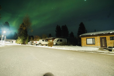Northern lights over street in Syvasenvaara in Rovaniemi, Laplandの写真素材