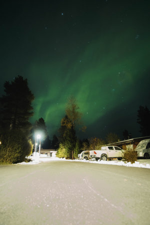 Aurora borealis over street in Syvasenvaara in Rovaniemi, Laplandの写真素材