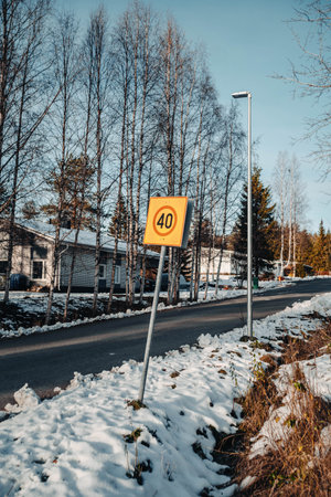 40kph yellow sign in Rovaniemi, Lapland in snowy autumnの写真素材