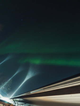 Northern lights above roof of house in Rovaniemi, Laplandの写真素材