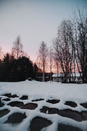 Snow on pavement in garden at sunrise in Rovaniemi, Laplandの写真素材