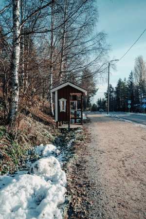 Red hut bus stop in Syvasenvaara in Rovaniemi, Lapland in autumnの写真素材