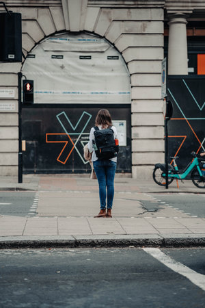 Woman waiting to cross road in London, UKの写真素材