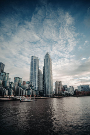 Plane in sky between skyscrapers in London, UKの写真素材