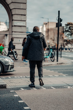 Man about to cross road in London, UKの写真素材