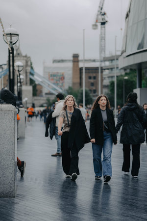 Women walking through central London, UK near Tower Bridgeの写真素材