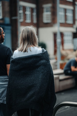 Woman in cardigan walking through London, UKの写真素材