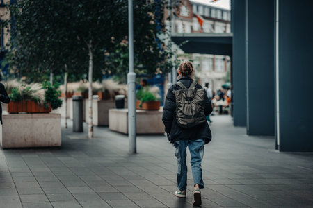 Woman walking down street near Tower Bridge in London, UK