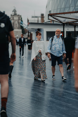 Couple walking through central London, UK near Tower Bridgeの写真素材