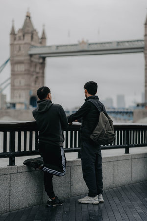Two men looking at Tower Bridge in London, UKの写真素材