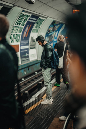 Man waiting for London Underground with headphones onの写真素材