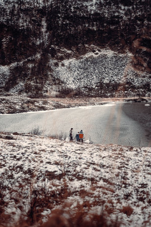 Tour group in snowy arctic tundra by frozen fjord near Tromso, Norwayの写真素材