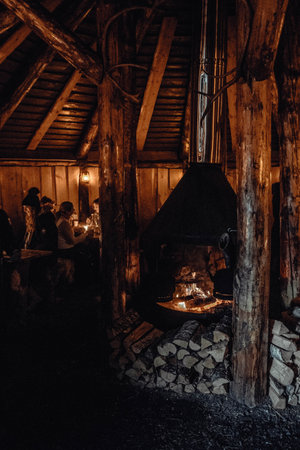 Fire burning inside wooden Saami hut in the arctic near Tromso, Norwayの写真素材