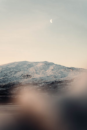 Moon in sky above mountain in the arctic circle in Tromso, Norway in autumn