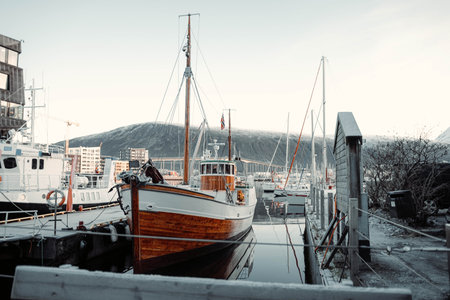 Traditional wooden fishing boat in Tromso harbour in arctic Norway in Novemberの写真素材