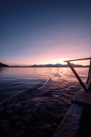 Pink sunset over arctic fjord outside Tromso, Norway in autumnの写真素材