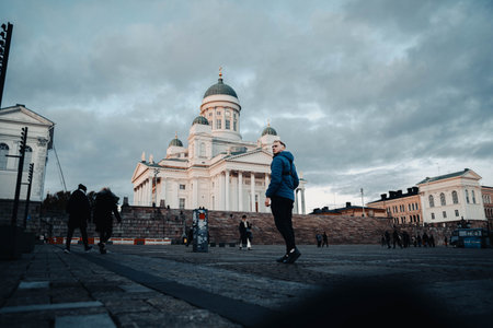Man walking towards Helsinki Cathedral at sunset in autumn in Finlandの写真素材